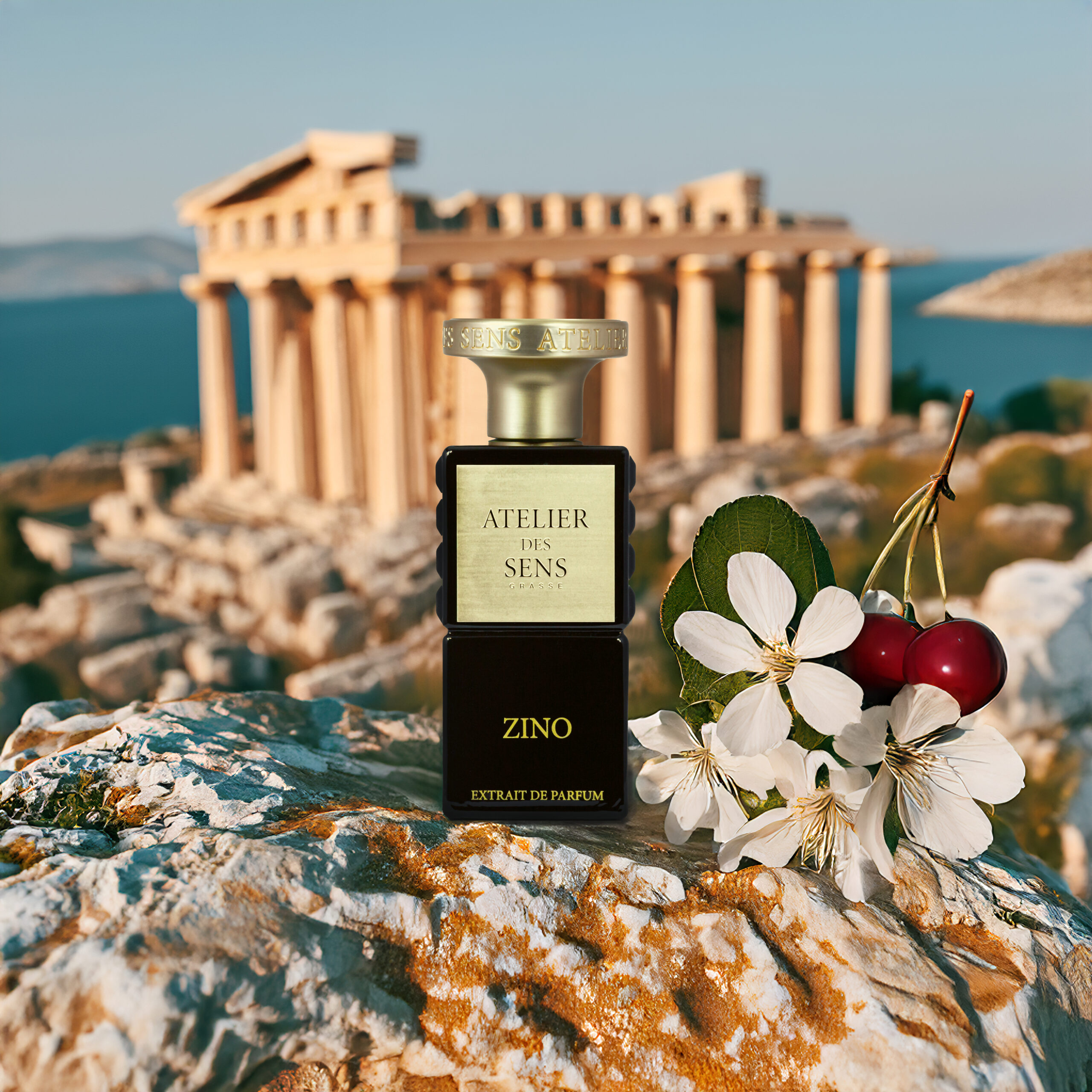 a bottle of perfume on a rock with flowers and cherries in the background